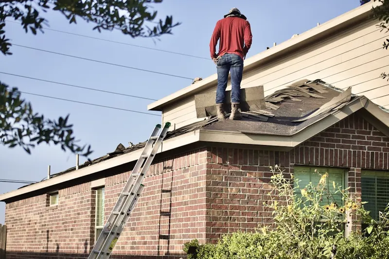 Professional roofer working on a residential roof in Caribou City